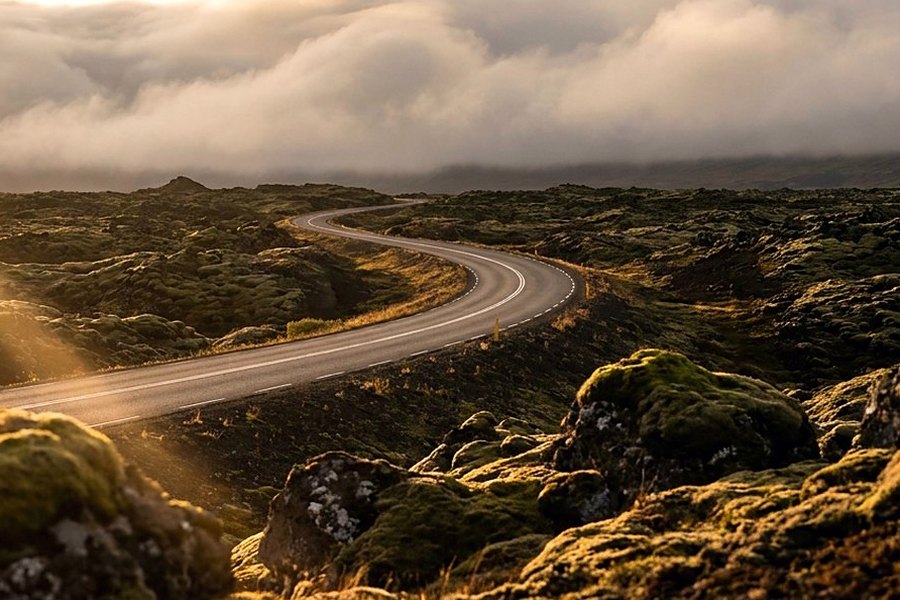 A mountain road switchback at golden hour